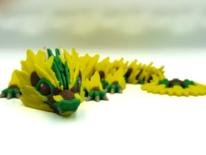 "3D printed sunflower flexi dragon," "flexible dragon toy," "sunflower dragon."